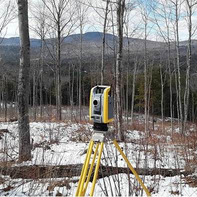 Site visit in the snow, North Country backdrop — Great North Woods Septic Design field photo