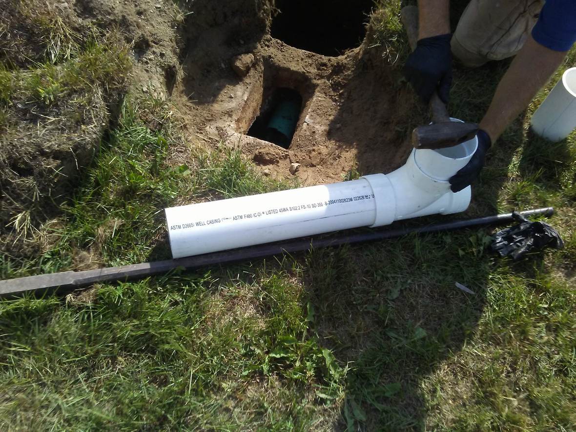 Connecting pipe fittings on site — Great North Woods Septic Design field photo