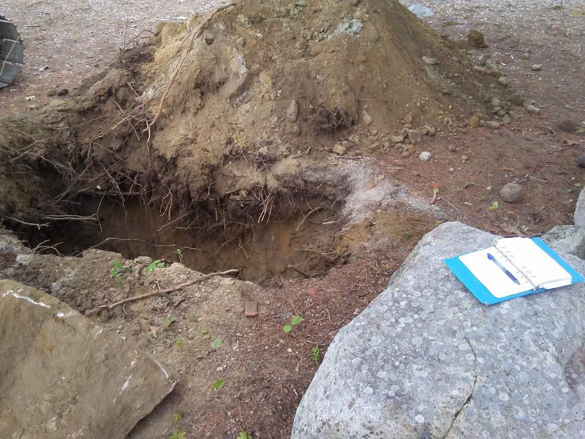 Soil profile exposed in a test pit — Great North Woods Septic Design field photo